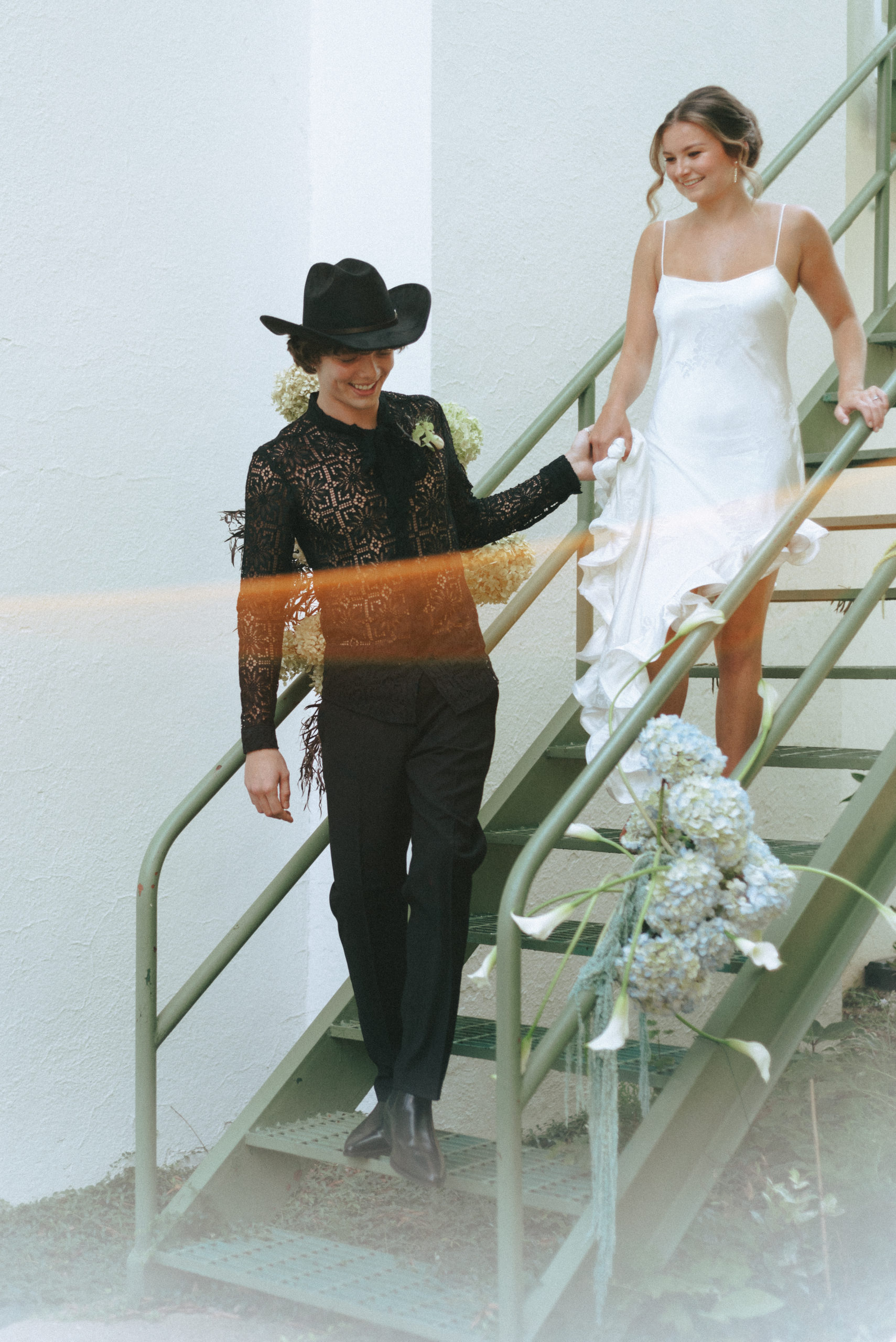 Gorgeous and young couple takes their vows to a new unique setting and decides to wed on a stairwell! We love it!